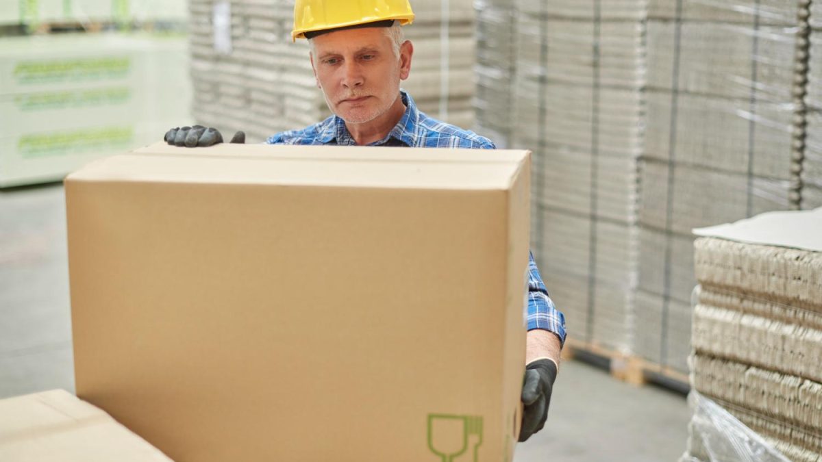 worker moving boxed art to Europe