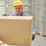 worker moving boxed art to Europe